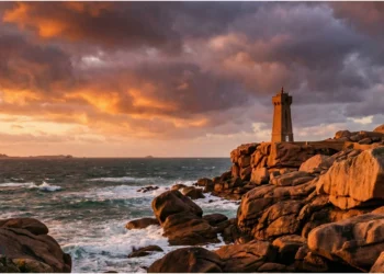 Le phare de Mean Ruz en granit rose s'intégrant parfaitement dans les rochers de Ploumanac'h sous un ciel de fin de journée.